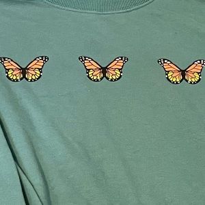 Green sweater with butterfly’s